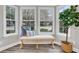 Inviting sitting area with large windows and a cushioned bench showcasing a comfortable and bright space at 718 Parish Rd, Charleston, SC 29407
