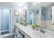 Bright bathroom featuring double sinks with marble countertop, framed mirrors, and stylish decor at 638 Stono Edge Dr, Charleston, SC 29412