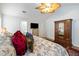 Bright bedroom featuring a ceiling fan, television, a patterned bed and antique wooden furniture at 638 Stono Edge Dr, Charleston, SC 29412