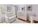 Cozy Bedroom with natural light, comfortable glider, and a classic white crib and changing table at 638 Stono Edge Dr, Charleston, SC 29412