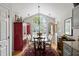 Light-filled dining room with a large window, hardwood floors, and a vintage display cabinet at 638 Stono Edge Dr, Charleston, SC 29412