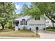 Charming white two-story home with an attached two-car garage and a well-manicured front lawn at 638 Stono Edge Dr, Charleston, SC 29412