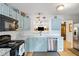 Bright, updated kitchen with light-blue cabinetry, stainless steel appliances, and granite countertops at 638 Stono Edge Dr, Charleston, SC 29412