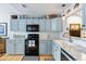 Cozy kitchen with light blue cabinets, modern appliances, and white tile backsplash at 638 Stono Edge Dr, Charleston, SC 29412