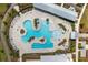Stunning aerial view of the expansive resort-style pool featuring lounge areas, splash pads, and lush landscaping at 716 Triangle Ln, Summerville, SC 29486
