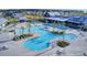 Aerial view of a community pool with surrounding palm trees, lounge chairs, and nearby houses at 716 Triangle Ln, Summerville, SC 29486
