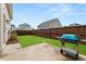 Well-maintained backyard featuring a concrete patio with a grill and green grass at 716 Triangle Ln, Summerville, SC 29486