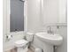 Clean bathroom featuring a pedestal sink, frosted window for privacy, and contemporary fixtures at 716 Triangle Ln, Summerville, SC 29486