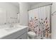 Clean bathroom featuring a gray vanity and floral shower curtain at 716 Triangle Ln, Summerville, SC 29486