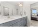 Bathroom features a double sink vanity with gray cabinets and modern fixtures and a large mirror at 716 Triangle Ln, Summerville, SC 29486