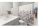 Neutral bathroom with a sleek vanity, a floral shower curtain, and a modern faucet at 716 Triangle Ln, Summerville, SC 29486