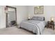 Comfortable bedroom showcases neutral tones, a large mirror, and a framed map art piece at 716 Triangle Ln, Summerville, SC 29486