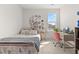 Bright bedroom featuring a desk, nightstand, shelving, and natural lighting at 716 Triangle Ln, Summerville, SC 29486