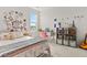 Comfortable bedroom with white iron bedframe, a desk, shelving, and natural lighting at 716 Triangle Ln, Summerville, SC 29486