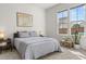 Bright bedroom showcases neutral tones, a framed map art piece, and natural light from large windows at 716 Triangle Ln, Summerville, SC 29486