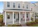 Charming front porch with sturdy white columns, a welcoming entryway, and meticulously cared for landscaping at 716 Triangle Ln, Summerville, SC 29486