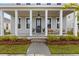 Inviting front porch featuring classic white columns, a charming entrance, and a well-manicured garden at 716 Triangle Ln, Summerville, SC 29486