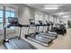 Wide angle view of treadmills and elliptical machines in a large gym with multiple windows for natural light at 716 Triangle Ln, Summerville, SC 29486