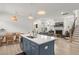 Modern kitchen island next to a dining area with a view of the fireplace in the living room at 716 Triangle Ln, Summerville, SC 29486
