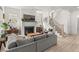 Open-concept living area with a fireplace, staircase, and a comfortable gray sectional sofa at 716 Triangle Ln, Summerville, SC 29486