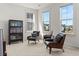 Bright living room features hardwood floors, large windows, and stylish mid century modern furniture at 716 Triangle Ln, Summerville, SC 29486