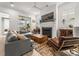 Spacious living room featuring a large fireplace, a modern ceiling fan, and lots of natural light at 716 Triangle Ln, Summerville, SC 29486