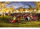 A large group enjoys an outdoor movie night at a community lawn event on a warm evening at 716 Triangle Ln, Summerville, SC 29486