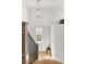 Elegant staircase with a wooden railing and a modern chandelier overhead, offering a sleek transition between floors at 716 Triangle Ln, Summerville, SC 29486