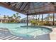 Resort style pool and cabana area with lush landscaping, a hot tub, and water features at 740 Blue Iris Way, Summerville, SC 29486