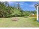 Lush backyard featuring well-maintained grass, trees with mulch beds, and partial view of the home's exterior at 802 S Pointe Blvd, Summerville, SC 29483