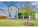 Large backyard with healthy lawn featuring the back of a beautiful two-story home with screened in porch at 802 S Pointe Blvd, Summerville, SC 29483
