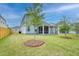 Expansive backyard featuring a screened porch, well-manicured lawn and landscaping of a charming two-story home at 802 S Pointe Blvd, Summerville, SC 29483