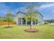 Expansive and green backyard featuring a screened-in porch, young trees, and partial fencing at 802 S Pointe Blvd, Summerville, SC 29483