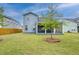Backyard view shows fenced yard, well maintained lawn and landscaping, as well as the screened porch at 802 S Pointe Blvd, Summerville, SC 29483