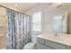 Bathroom featuring a vanity, shower with curtain and a window providing natural light at 802 S Pointe Blvd, Summerville, SC 29483