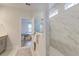 Modern marble tiled shower in the bathroom, view into the main bedroom, light and bright at 802 S Pointe Blvd, Summerville, SC 29483