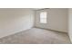 This bedroom features neutral walls, carpet, a window providing bright, natural light and a closet at 802 S Pointe Blvd, Summerville, SC 29483