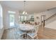 Open dining area featuring a distressed table, stylish chairs, and easy access to the backyard at 802 S Pointe Blvd, Summerville, SC 29483