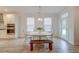 Dining room boasts a classic table and chairs, natural light from windows, and a door to the outside at 802 S Pointe Blvd, Summerville, SC 29483