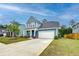 Charming blue two-story home with a front porch, attached garage, and well-maintained lawn at 802 S Pointe Blvd, Summerville, SC 29483