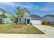 Attractive home with a well-kept lawn, a two-car garage, and a welcoming front porch at 802 S Pointe Blvd, Summerville, SC 29483