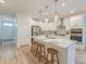 Modern kitchen featuring white cabinets, stainless steel appliances, and a large island with stool seating at 802 S Pointe Blvd, Summerville, SC 29483