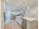 Spacious open kitchen featuring quartz counters, island seating, view to dining area, and stainless appliances at 802 S Pointe Blvd, Summerville, SC 29483