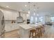 Open kitchen with white cabinets, stainless appliances, an island with seating, and a view to dining area at 802 S Pointe Blvd, Summerville, SC 29483