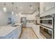 Bright kitchen with white cabinets, stainless steel appliances, and a kitchen island with a sink at 802 S Pointe Blvd, Summerville, SC 29483