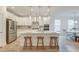 Modern kitchen with white cabinets, stainless steel appliances, and a large central island at 802 S Pointe Blvd, Summerville, SC 29483