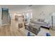 Bright open-concept living room featuring a sofa, decorative art, hardwood floors and stairs to the upper level at 802 S Pointe Blvd, Summerville, SC 29483