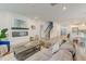 Open-concept living room featuring a modern fireplace, plush seating, and beautiful hardwood floors at 802 S Pointe Blvd, Summerville, SC 29483