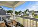 Balcony view with wood flooring, two chairs, table, potted plants, and a view of the neighborhood at 8402 Loggers Run, North Charleston, SC 29420