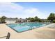 Spacious community pool with multiple lounge chairs and cabana, offering a perfect summer escape at 8402 Loggers Run, North Charleston, SC 29420